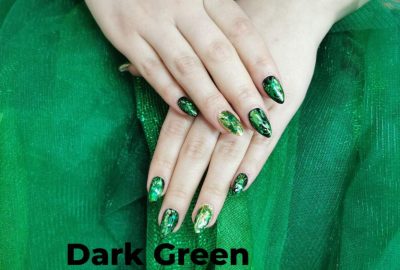 Showcasing dark green nail trends for 2024: glossy finishes, matte textures, and artistic designs for a chic look